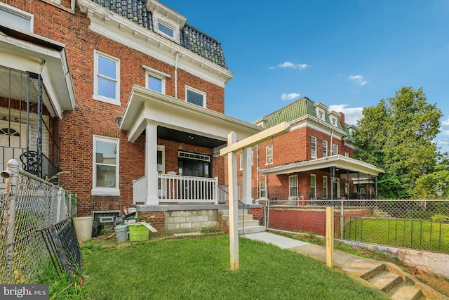 2817 Ulman Ave, Baltimore, MD 21215 - view of front of house with mansard roof, a porch, and brick siding