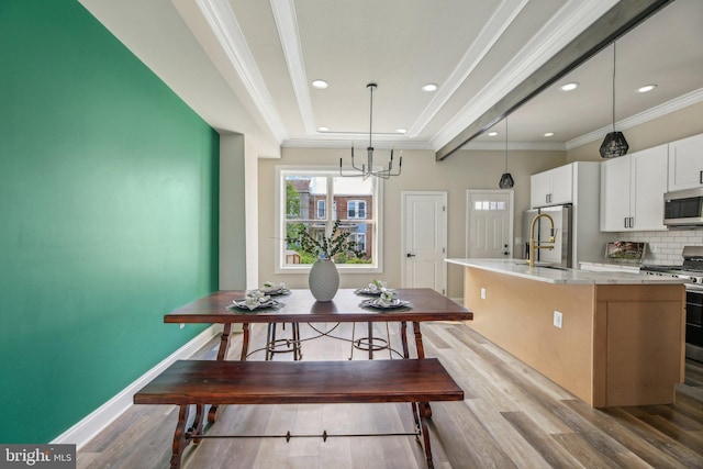 2817 Ulman Ave, Baltimore, MD 21215 - dining space with light wood-style flooring, a chandelier, recessed lighting, crown molding, and baseboards