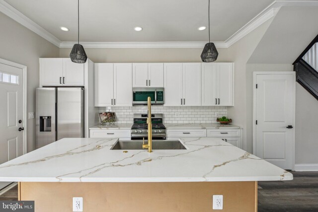 2817 Ulman Ave, Baltimore, MD 21215 - kitchen with appliances with stainless steel finishes, dark wood-type flooring, a kitchen island with sink, decorative backsplash, and crown molding