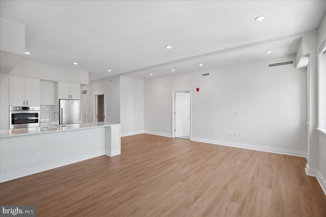 923 V St NW Unit 602, Washington, DC 20001 - unfurnished living room with recessed lighting and light wood-style floors