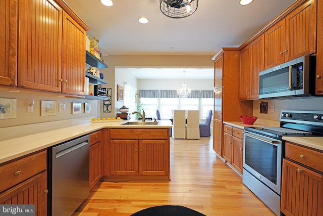 102 Morgan Way, Milton, DE 19968 - kitchen featuring stainless steel appliances, a sink, a peninsula, a chandelier, and recessed lighting