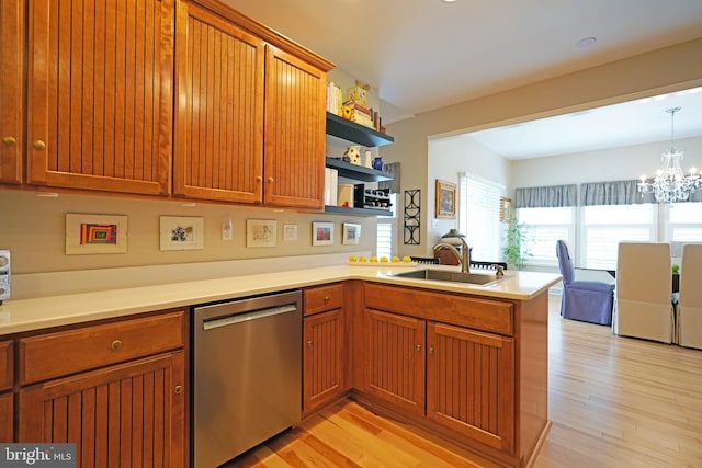 102 Morgan Way, Milton, DE 19968 - kitchen featuring dishwasher, a sink, a peninsula, open shelves, and light wood-style floors