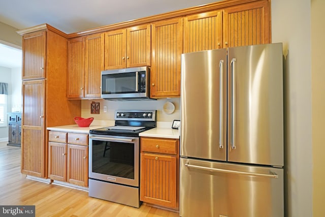 102 Morgan Way, Milton, DE 19968 - kitchen featuring stainless steel appliances, light wood-type flooring, and light countertops