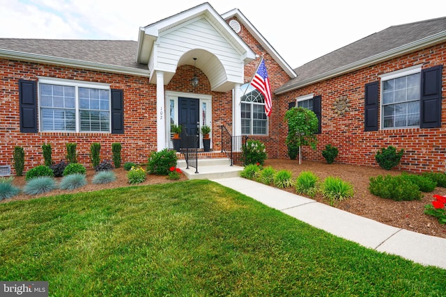 102 Morgan Way, Milton, DE 19968 - view of front of home with a front yard, brick siding, and a shingled roof