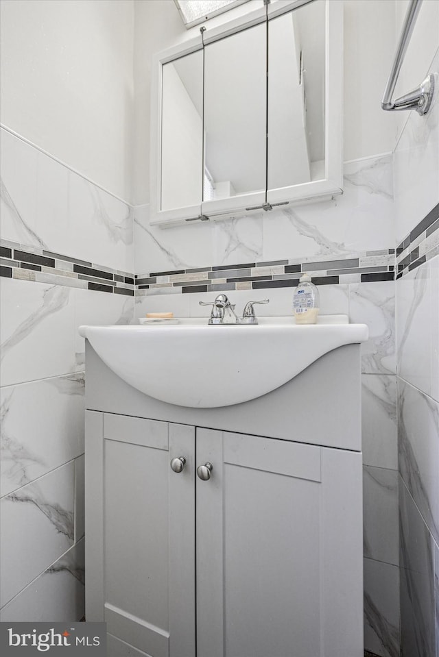bathroom with tile walls and vanity