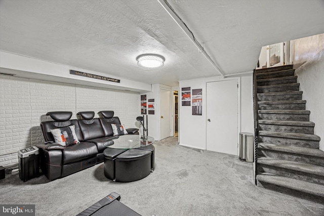 living room with carpet floors, a textured ceiling, and stairway