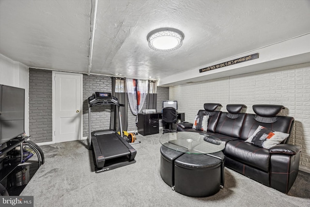 carpeted living area featuring a textured ceiling and brick wall