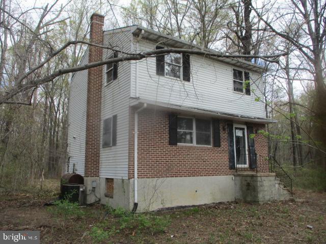 2014 Leland Ave, Baltimore, MD 21220 - view of front of home featuring brick siding and a chimney