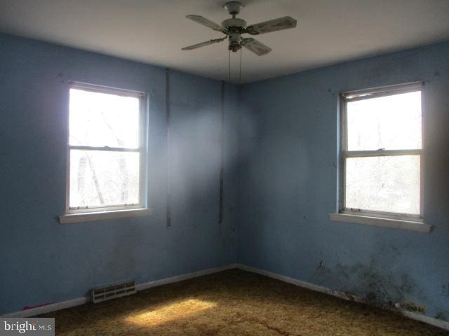2014 Leland Ave, Baltimore, MD 21220 - carpeted spare room featuring a healthy amount of sunlight, a ceiling fan, and visible vents