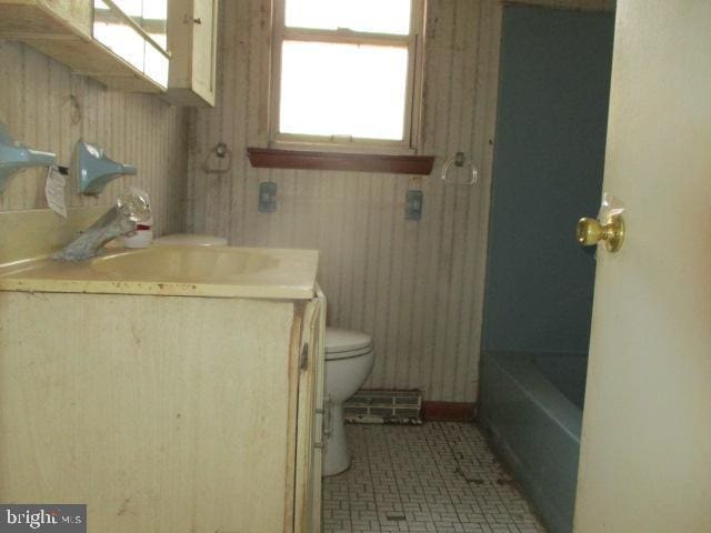 2014 Leland Ave, Baltimore, MD 21220 - bathroom with vanity, a shower, a tub, and toilet