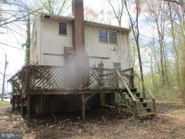 2014 Leland Ave, Baltimore, MD 21220 - rear view of property with a wooden deck, stairs, and a chimney