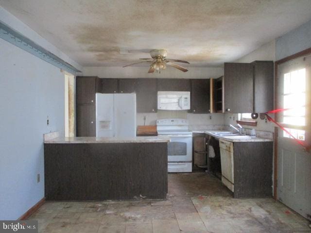 2014 Leland Ave, Baltimore, MD 21220 - kitchen with ceiling fan, a sink, white appliances, light countertops, and a peninsula