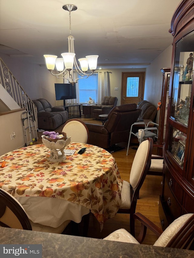 3017 S 17th St, Philadelphia, PA 19145 - dining space featuring wood finished floors, a chandelier, and stairway