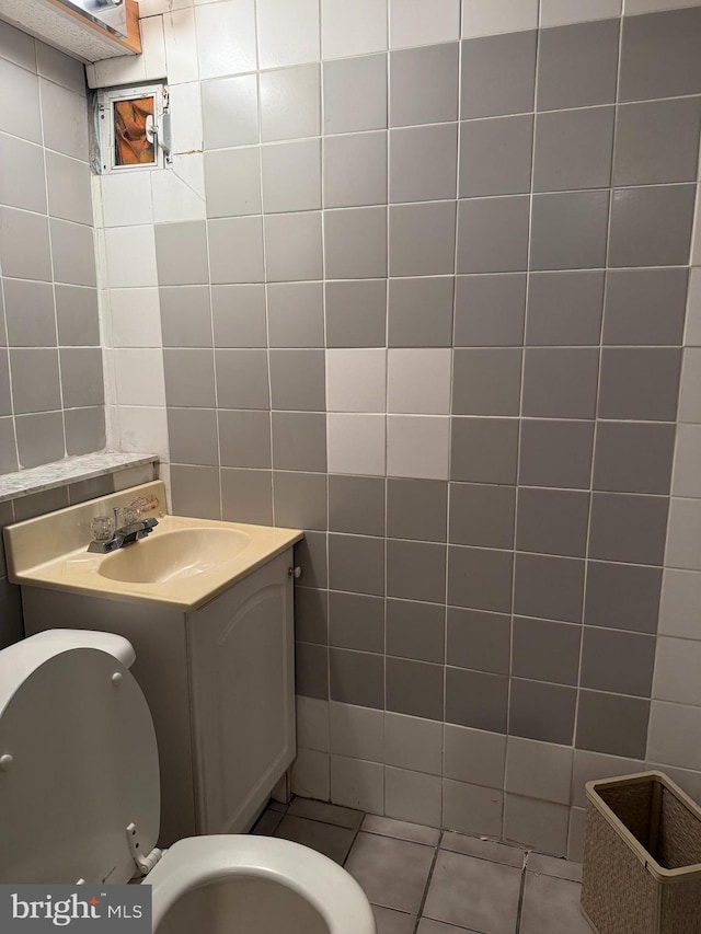 3017 S 17th St, Philadelphia, PA 19145 - half bath with tile walls, tile patterned floors, vanity, and toilet