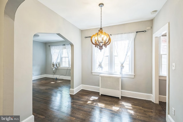 208 Farragut St NW Unit 104, Washington, DC 20011 - unfurnished dining area featuring radiator, arched walkways, a chandelier, and wood finished floors