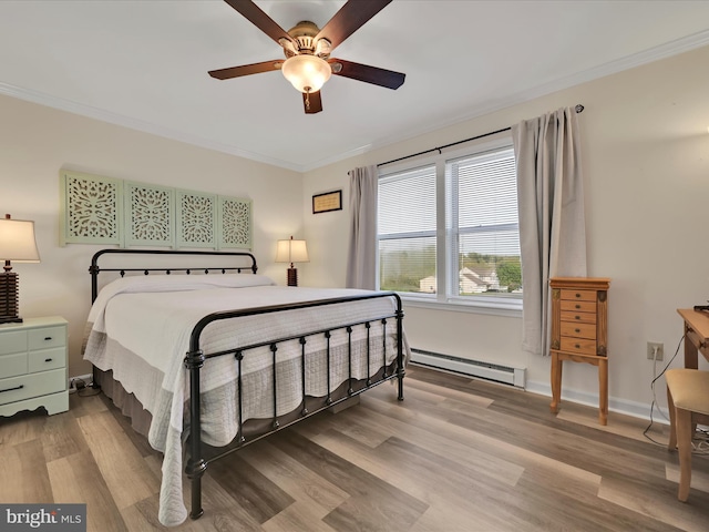 bedroom featuring crown molding, wood finished floors, baseboards, baseboard heating, and a ceiling fan
