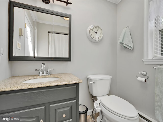 bathroom featuring crown molding, vanity, toilet, baseboards, and baseboard heating