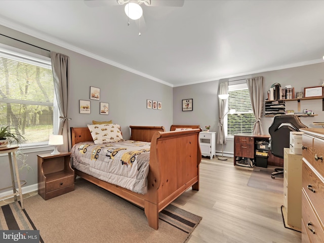 bedroom featuring crown molding, baseboards, ceiling fan, and light wood-type flooring