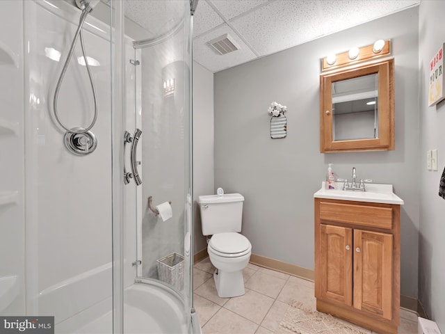 full bath featuring vanity, tile patterned floors, a drop ceiling, visible vents, and a stall shower