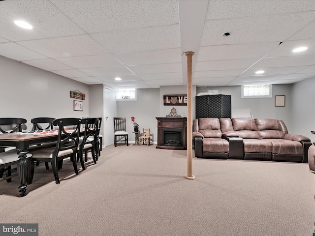 carpeted living area featuring recessed lighting, a paneled ceiling, and a fireplace