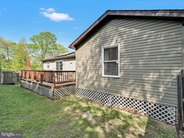 exterior space with fence, a yard, and a deck