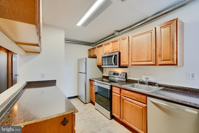 702 S Wolfe St Unit 5, Baltimore, MD 21231 - kitchen with appliances with stainless steel finishes, a sink, and dark countertops