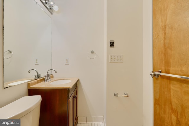 702 S Wolfe St Unit 5, Baltimore, MD 21231 - half bath with vanity, toilet, and tile patterned flooring