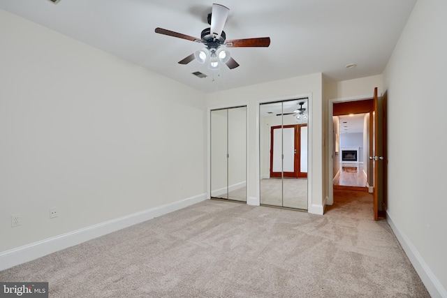 702 S Wolfe St Unit 5, Baltimore, MD 21231 - unfurnished bedroom featuring multiple closets, carpet, baseboards, and a ceiling fan