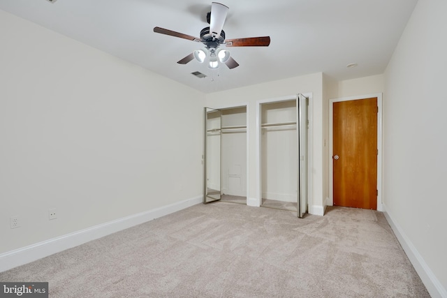 702 S Wolfe St Unit 5, Baltimore, MD 21231 - unfurnished bedroom with two closets, light carpet, baseboards, and ceiling fan