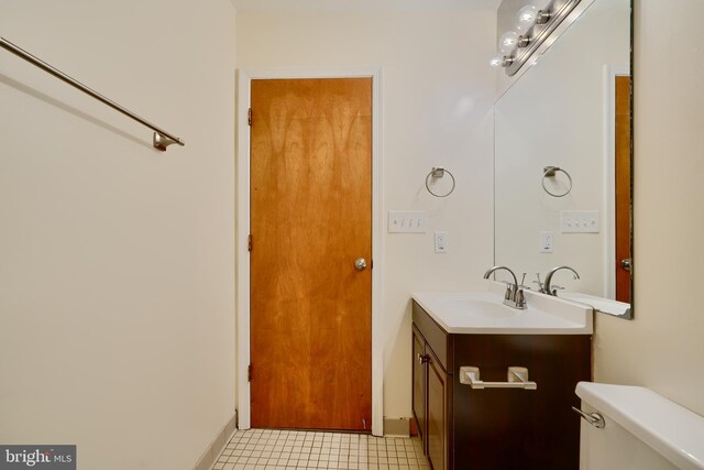 702 S Wolfe St Unit 5, Baltimore, MD 21231 - half bathroom with toilet, vanity, and baseboards