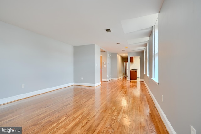 702 S Wolfe St Unit 5, Baltimore, MD 21231 - unfurnished living room featuring light wood-style flooring and baseboards