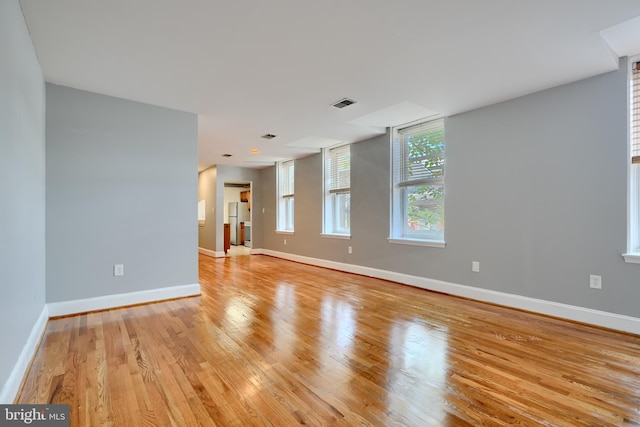 702 S Wolfe St Unit 5, Baltimore, MD 21231 - unfurnished room with baseboards and light wood-style flooring