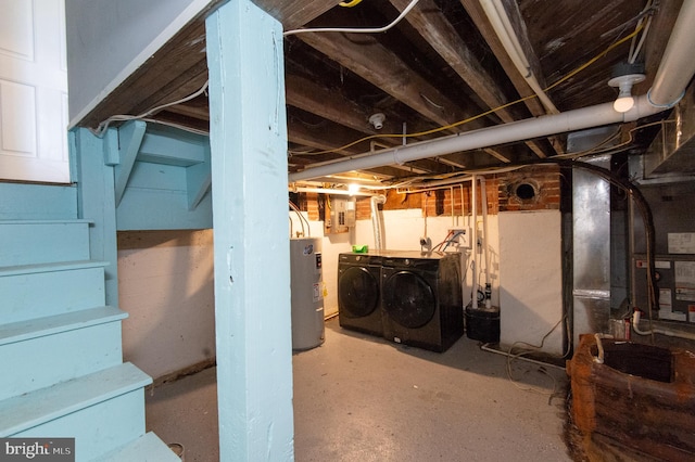 unfinished below grade area featuring washer and clothes dryer, water heater, and stairway