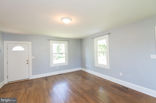 foyer with baseboards and dark wood-style floors