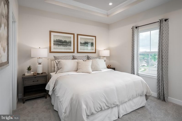 bedroom featuring baseboards, recessed lighting, a tray ceiling, and light carpet