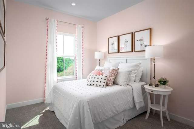 carpeted bedroom featuring baseboards
