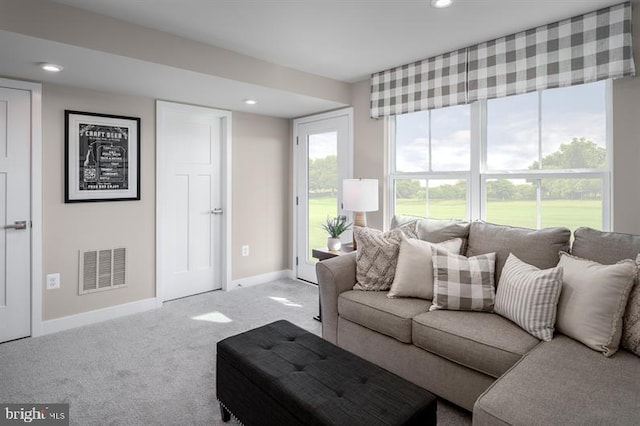 carpeted living area with baseboards, recessed lighting, and visible vents