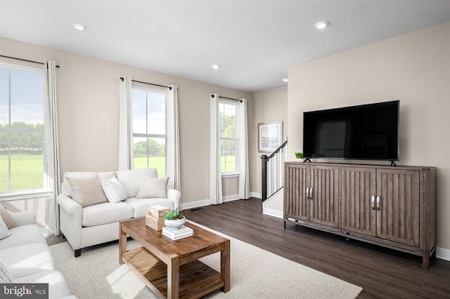living area featuring recessed lighting, baseboards, and wood finished floors