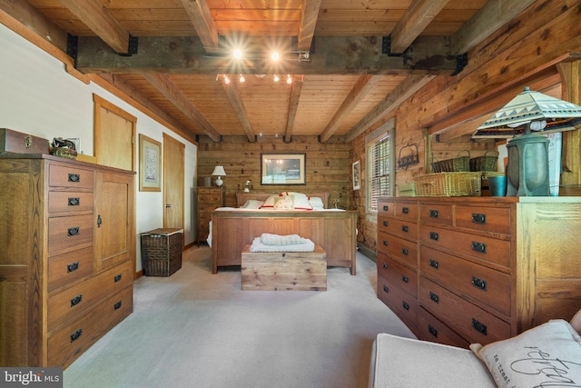 bedroom featuring wooden walls, wooden ceiling, beam ceiling, and light carpet