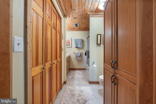 bathroom featuring vanity, toilet, wood ceiling, tile patterned floors, and combined bath / shower with glass door
