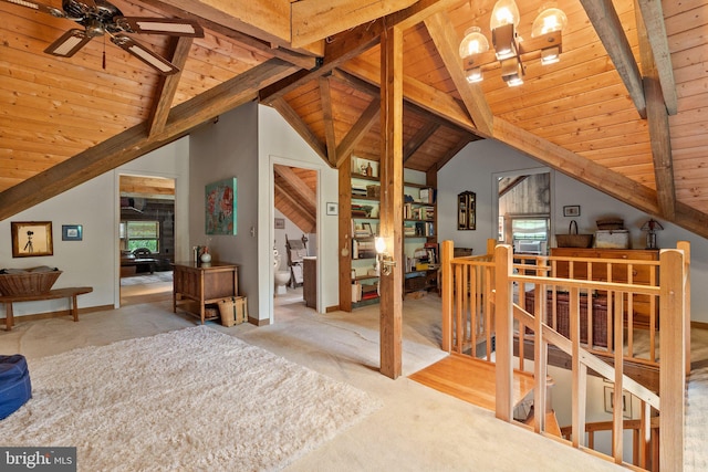 additional living space featuring lofted ceiling with beams, carpet, a ceiling fan, baseboards, and wooden ceiling