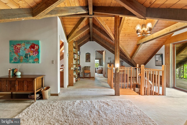 interior space with lofted ceiling with beams, wooden ceiling, a wealth of natural light, and carpet