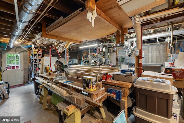 miscellaneous room featuring a workshop area and concrete flooring