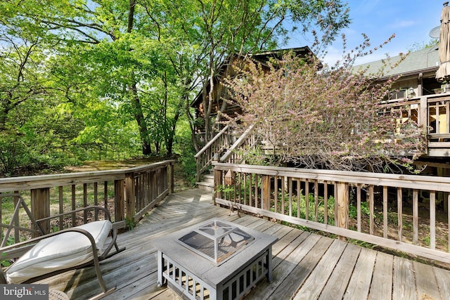 deck with stairs and an outdoor fire pit