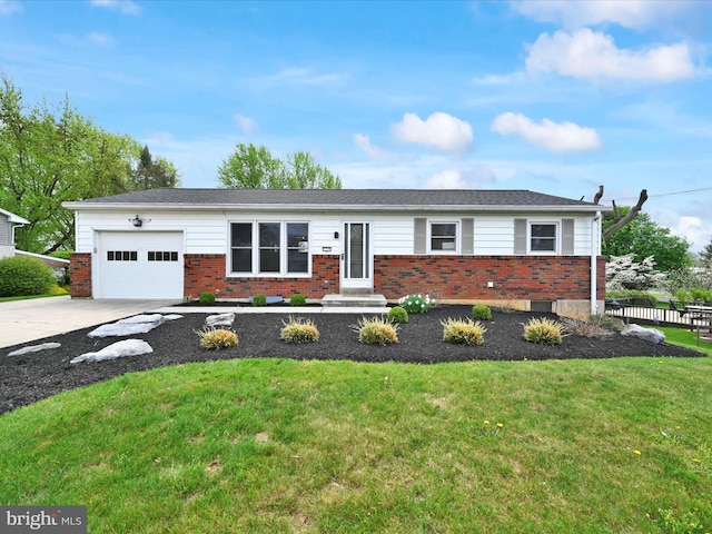 single story home with a garage, concrete driveway, a front yard, and brick siding