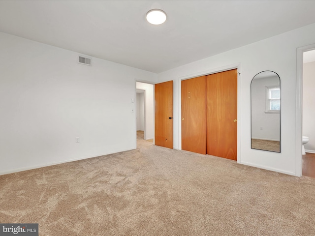218 W Franklin Ave, Myerstown, PA 17067 - unfurnished bedroom with connected bathroom, carpet floors, baseboards, visible vents, and a closet