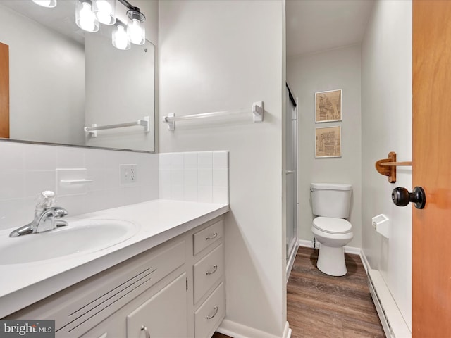 218 W Franklin Ave, Myerstown, PA 17067 - bathroom with vanity, wood finished floors, toilet, a shower stall, and backsplash