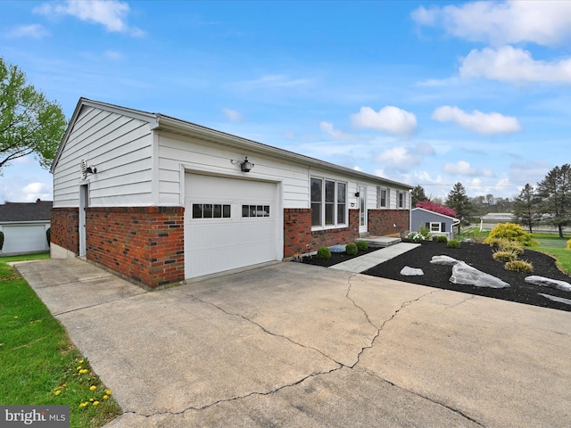 single story home with brick siding, a garage, and concrete driveway