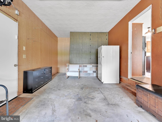 218 W Franklin Ave, Myerstown, PA 17067 - interior space with freestanding refrigerator and wood walls