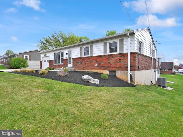 218 W Franklin Ave, Myerstown, PA 17067 - view of front of home featuring brick siding, central AC, a front yard, and a garage
